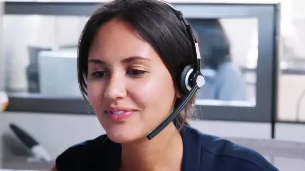 smiling female call center agent talking on a headset